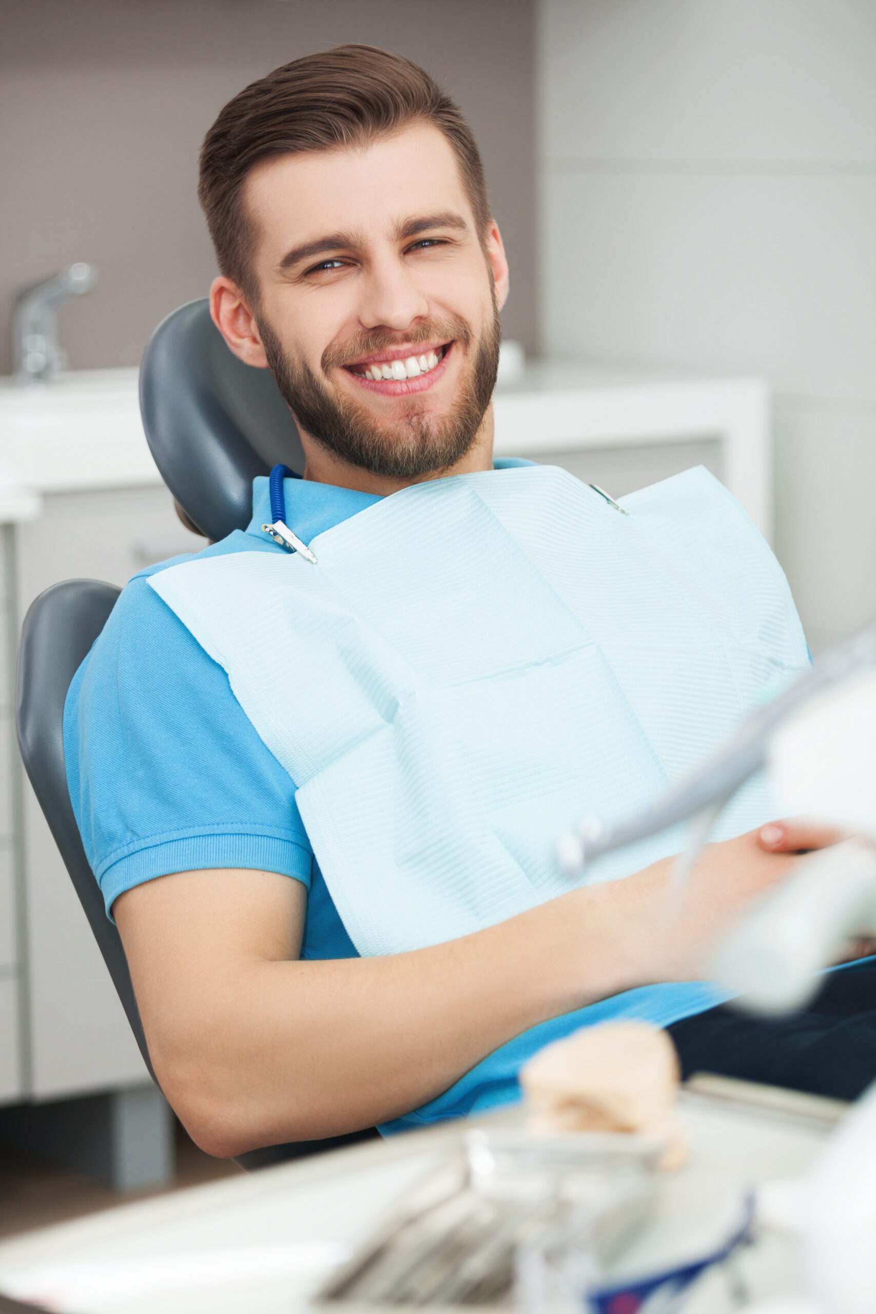 My smile is perfect! Portrait of happy patient in dental chair.