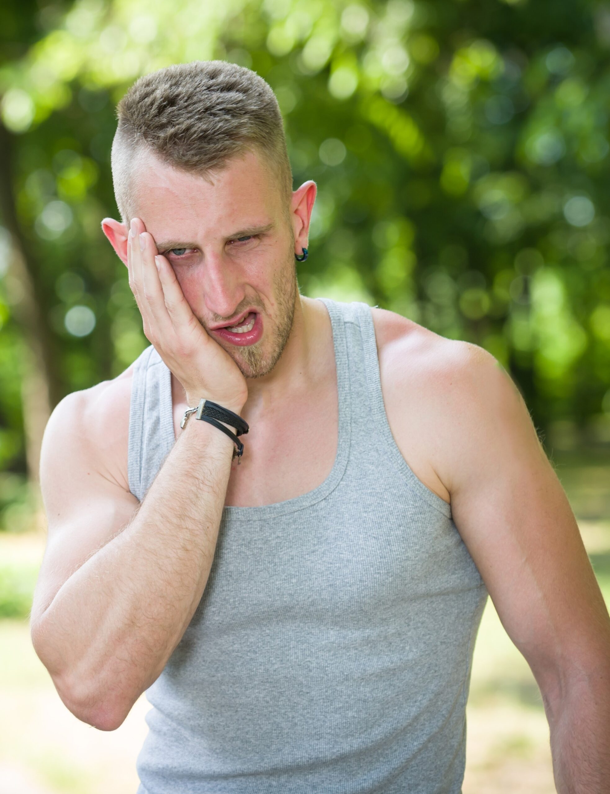sport man toothache in a park