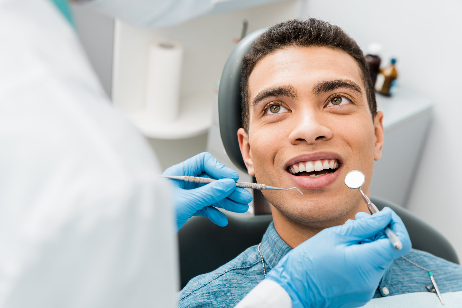 cheerful african american man with during examination in dental clinic