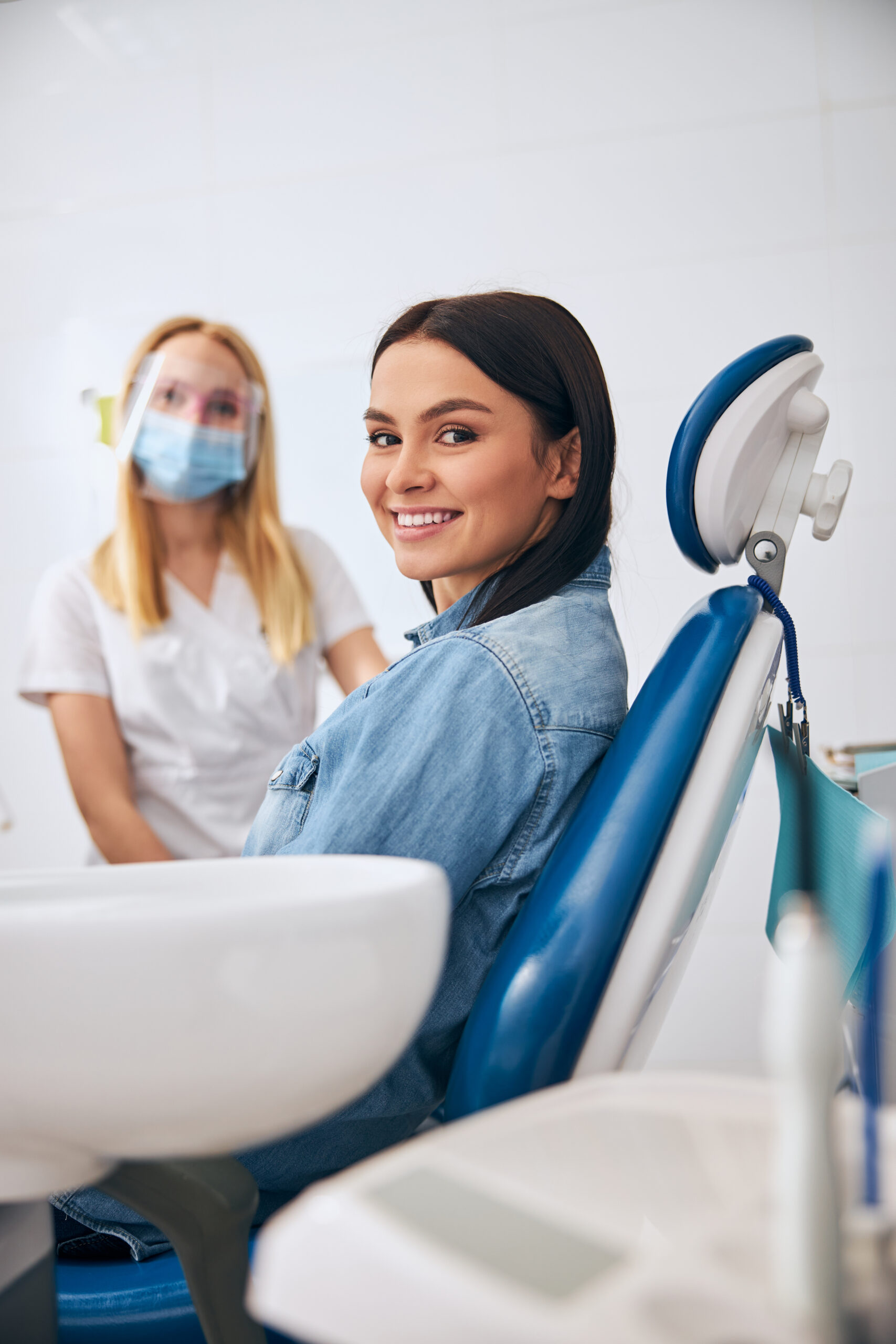 Charming young female person demonstrating her smile while being at dental examination